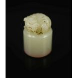 A Chinese white jade cylindrical seal,surmounted by the figure of a lion dog, inscription to one