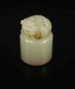 A Chinese white jade cylindrical seal,surmounted by the figure of a lion dog, inscription to one