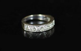 A modern white gold and channel set seven stone diamond half hoop ring,size P/Q, gross weight 6.4