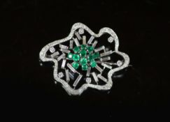 A white gold, emerald and diamond set open work modernist brooch,set with round and baguette cut