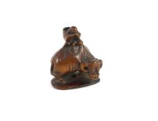 A Japanese boxwood netsuke of Semimaru playing the flute and riding upon an ox, School of