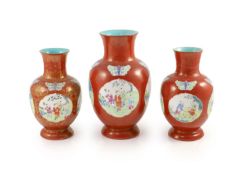 A set of three Chinese coral ground ‘boys’ vases, Jiaqing period (1796-1820),each painted in famille