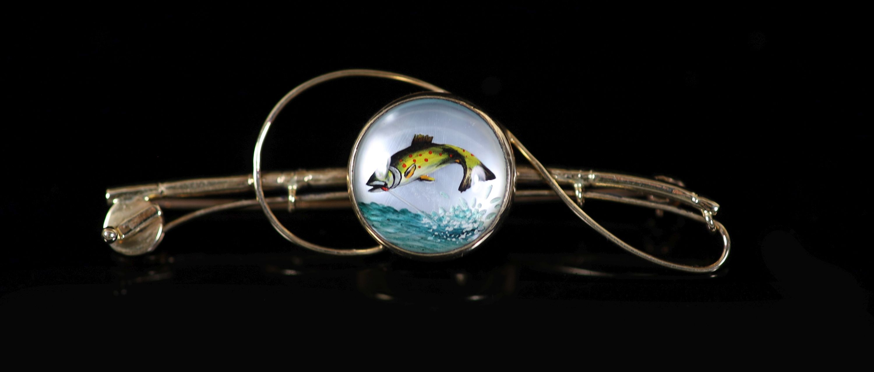 An Edwardian 18ct gold and Essex crystal set bar brooch, modelled as a fly fishing rod, with line