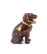 A Chinese brown glazed porcelain model of a seated dog, Qianlong period,wearing a yellow collar