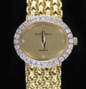 A lady's 18ct gold Baume & Mercier quartz oval dress bracelet wrist watch, with diamond set bezel,