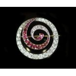 An early 20th century gold and silver, graduated ruby and diamond set open work whorl brooch,27mm,