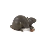 A Japanese two colour bronze figure of a rat, Meiji period, signed Seishu,the rat holding a chestnut