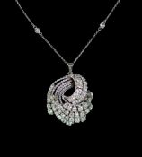 A modern white gold and graduated diamond set fan shaped scroll pendant, on a eight stone diamond