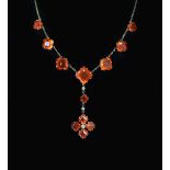 An early 20th century gold, fire opal and diamond drop necklace,set with twelve square cut opals (