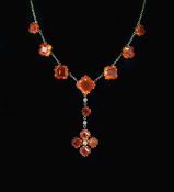An early 20th century gold, fire opal and diamond drop necklace,set with twelve square cut opals (