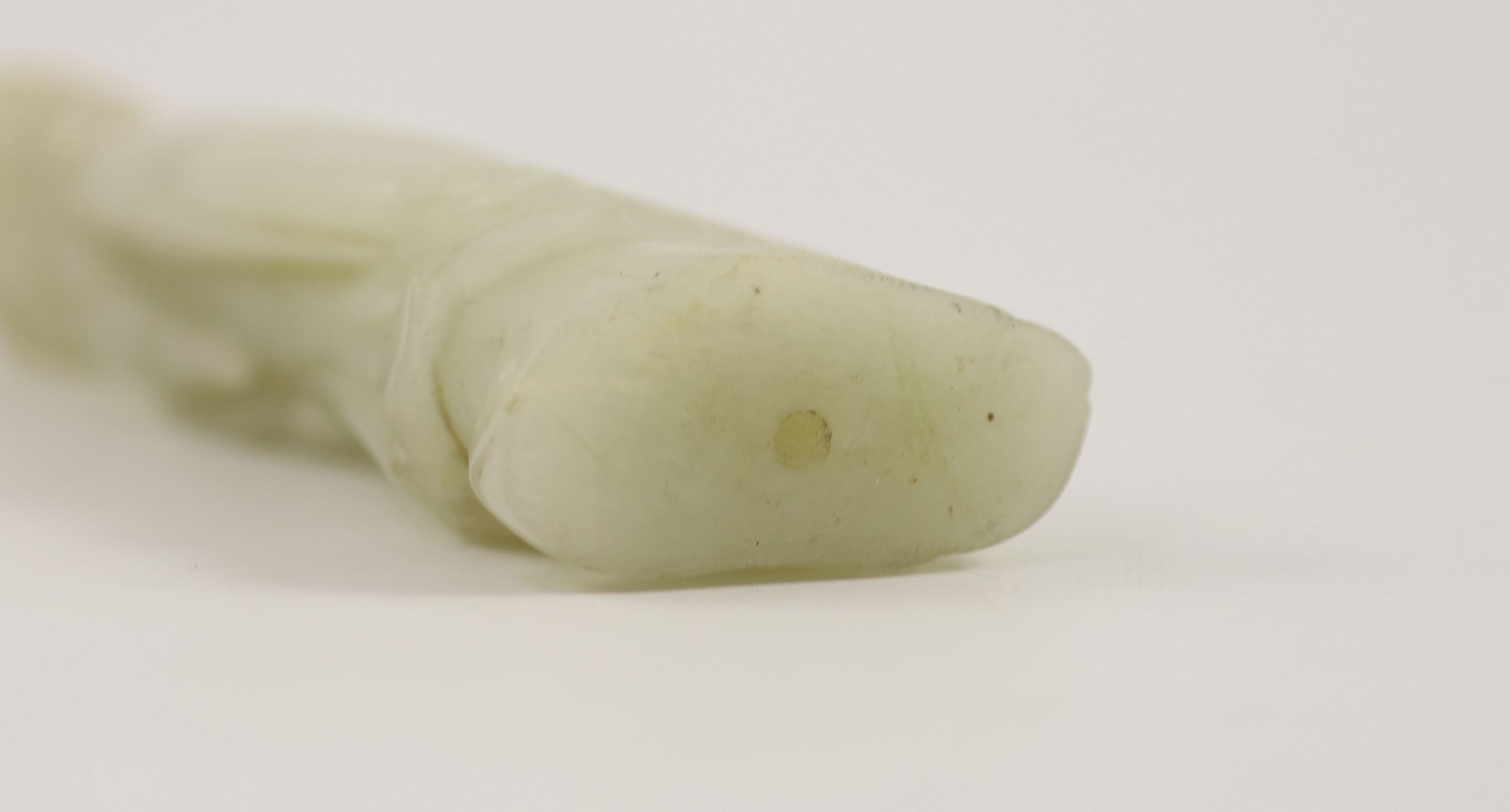 A Chinese pale celadon jade figure of a lady, 18th century,standing and holding a flower sprig, - Image 3 of 3