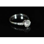 An 18ct white gold and single stone diamond ring,with six stone diamond set shoulders, the central