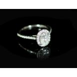 A Rox platinum and oval cut single stone diamond ring, with diamond set border and diamond set