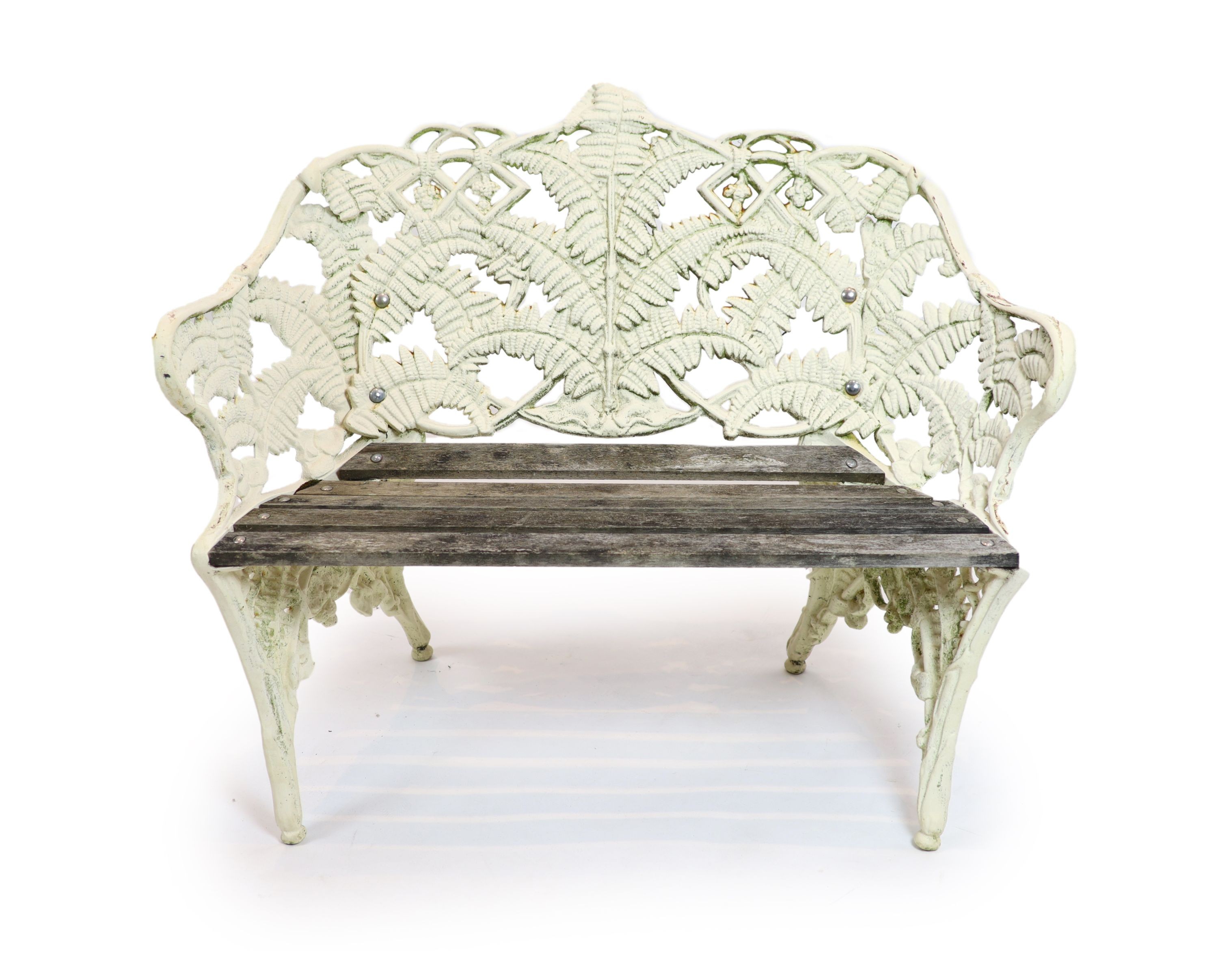 A Victorian cast iron Coalbrookdale 'Fern' pattern garden benchpainted white, with wooden slats to