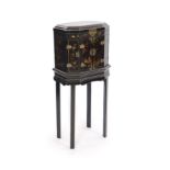 An 18th century Japanese black lacquered table cabinet on standdecorated with chinoiserie landscapes