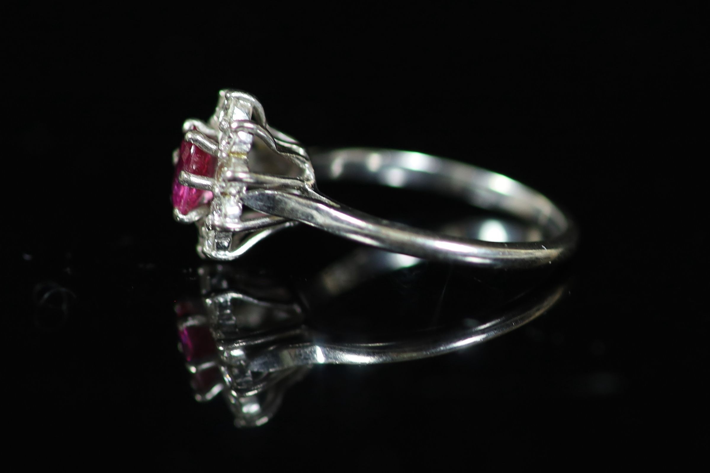 A white gold, ruby and diamond set flower head cluster ring,with central oval cut ruby, size R, - Image 2 of 3
