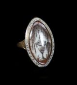 A George III enamelled gold memorial ring, inset with an ivory plaquewith painted and hairwork panel