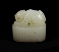 A Chinese white jade and oval 'crouching cat' seal,inscribed to one side, with carved matrix, the
