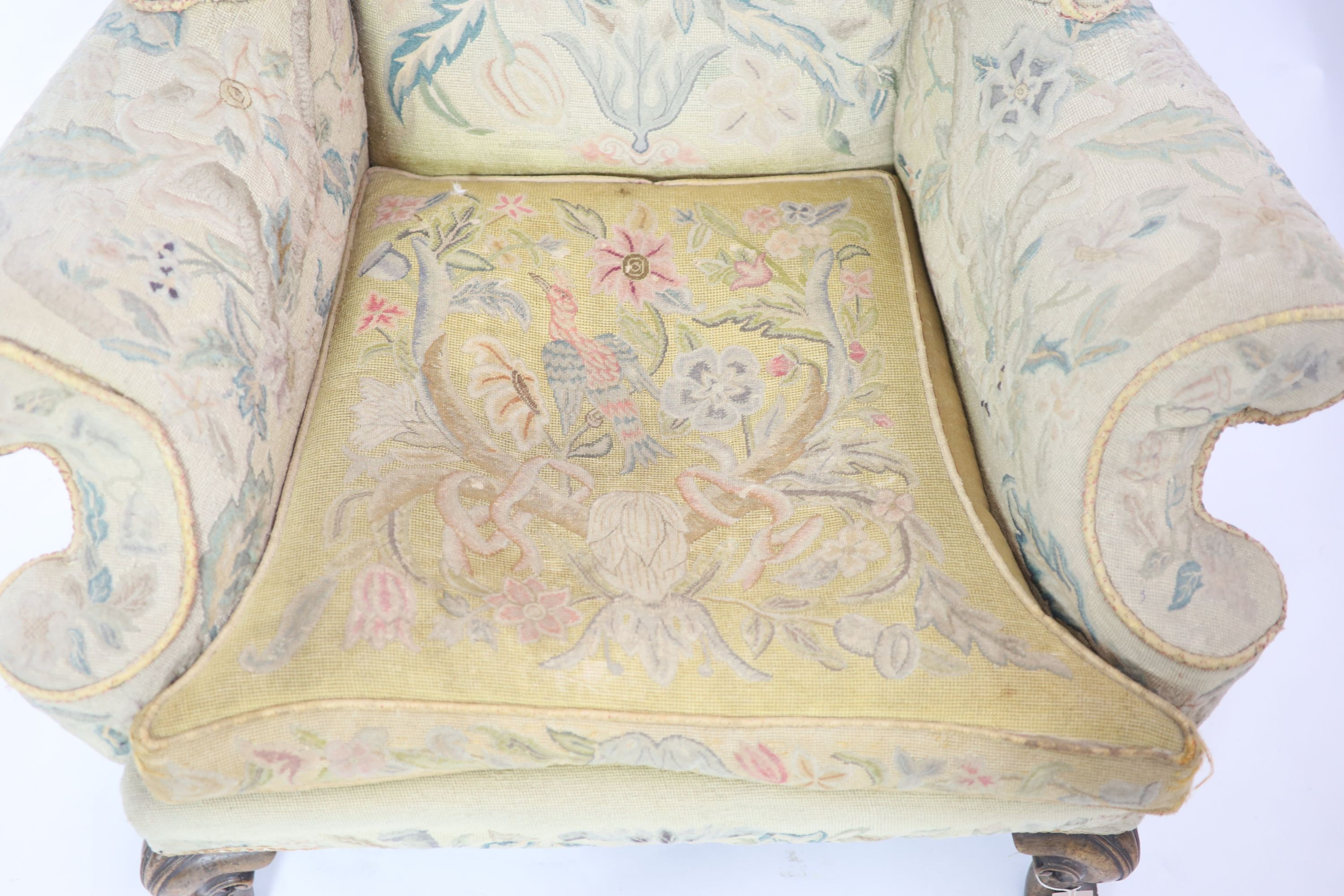 A pair of Georgian style mahogany wing armchairsof generous proportions, upholstered in faded - Image 4 of 6