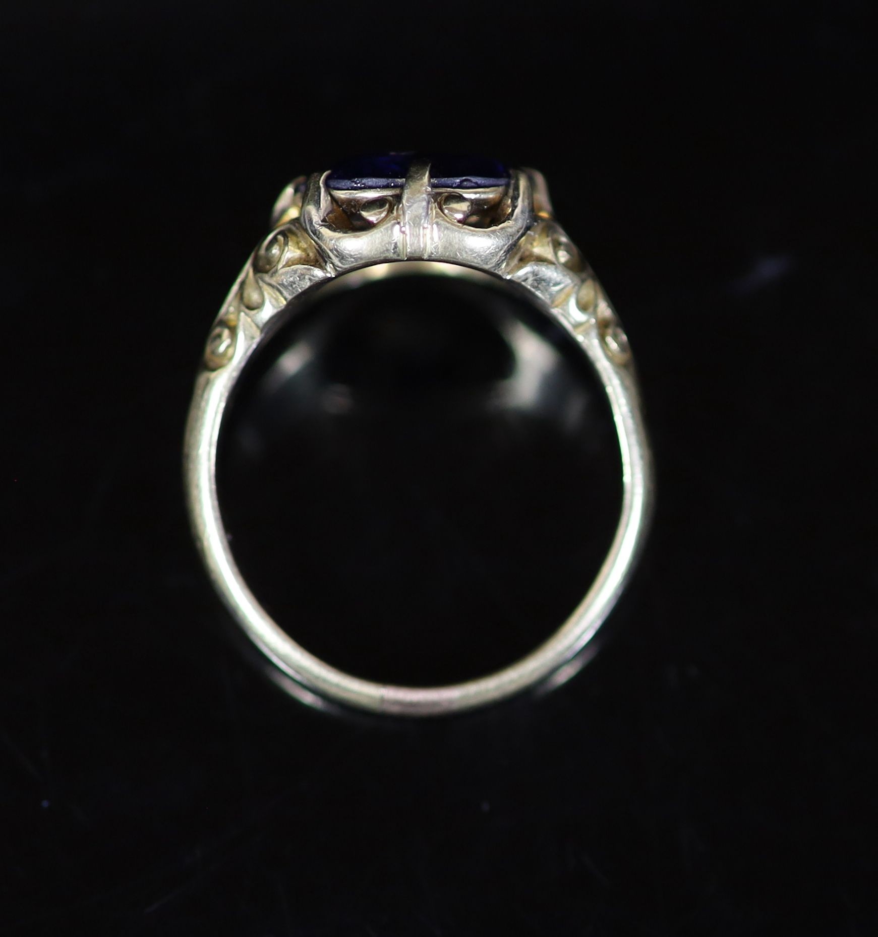 An 18ct gold and single stone claw set sapphire ring,with closed back setting and carved shoulders - Image 3 of 3