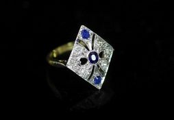 A 1920's/1930's 18ct gold and platinum, millegrain set sapphire and diamond pierced diamond shaped