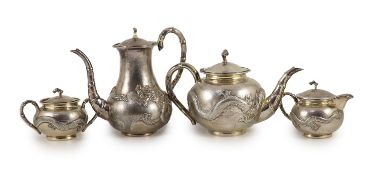 A matched early 20th century Chinese four piece planished silver tea and coffee set, cream and sugar
