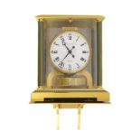 A Jaeger le Coultre gilt brass Atmos clock,with fluted columns and white enamelled Roman and
