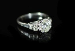 A platinum and single stone diamond ring, with six stone rose cut diamond set shoulders,the