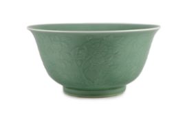 A fine large Chinese moulded celadon-glazed bowl, Qianlong seal mark and of the period (1736-95),the