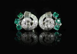 A pair of 1950's white gold, emerald and diamond cluster scroll ear clips,set with square cut