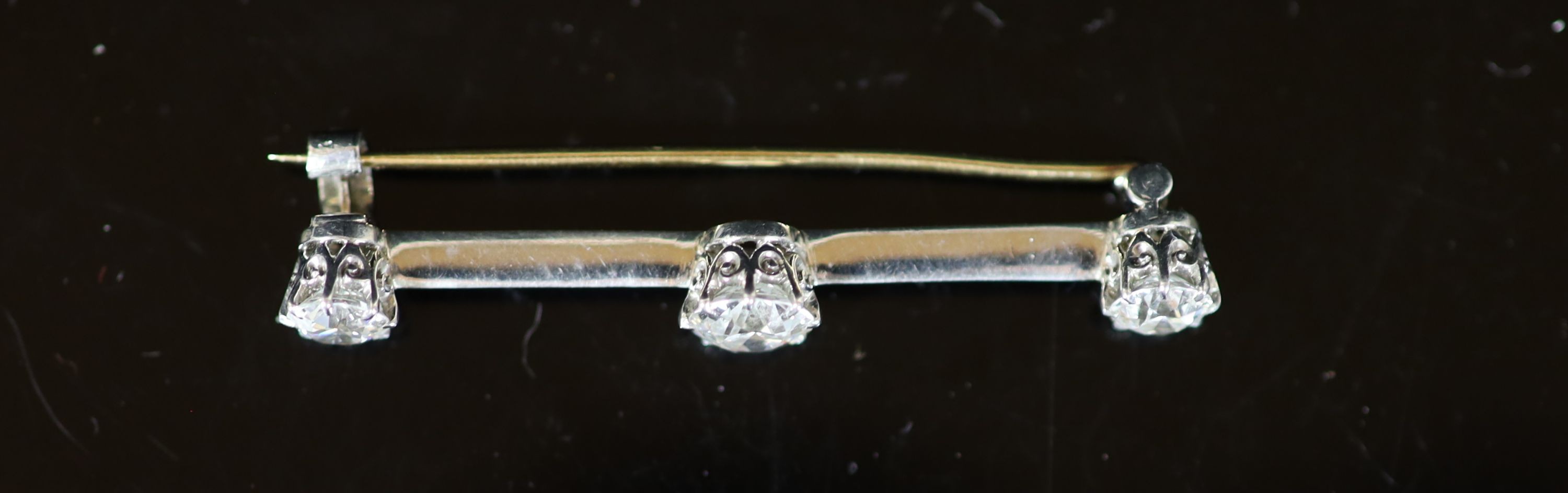 A gold, platinum and three stone diamond set bar brooch,45mm, gross weight 4.6 grams, the largest - Image 2 of 2