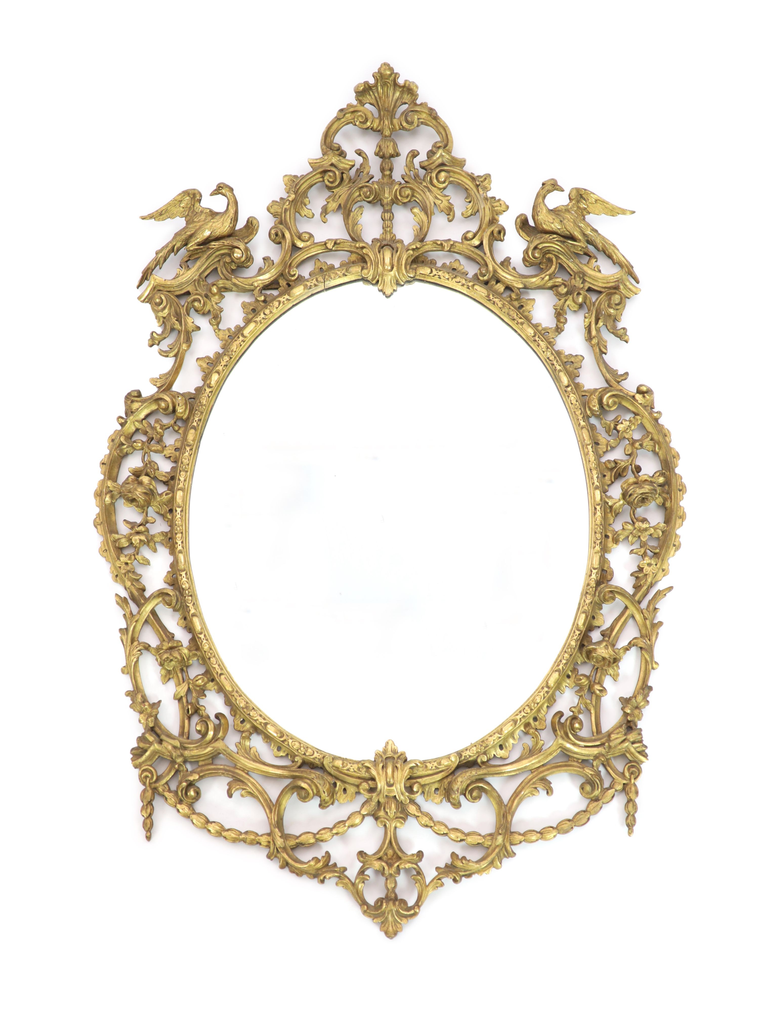 A 19th century Chippendale style gilt and gesso wall mirrorwith ornate foliate scroll frame capped