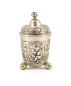 An 18th century possibly German silver cup and cover,embossed with putti gathering fruit, on three