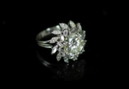 A platinum and single stone diamond ring, with baguette and marquise cut diamond foliate setting,the