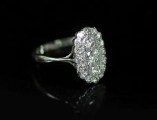 A 1940's 18ct white gold and diamond set oval cluster ring,size O/P, gross weight 3 grams.