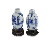 A pair of Chinese blue and white ovoid jars and covers, Kangxi period,each painted with ladies in