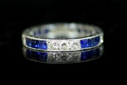 A platinum, sapphire and diamond set full eternity ring,with engraved shank and set with alternating