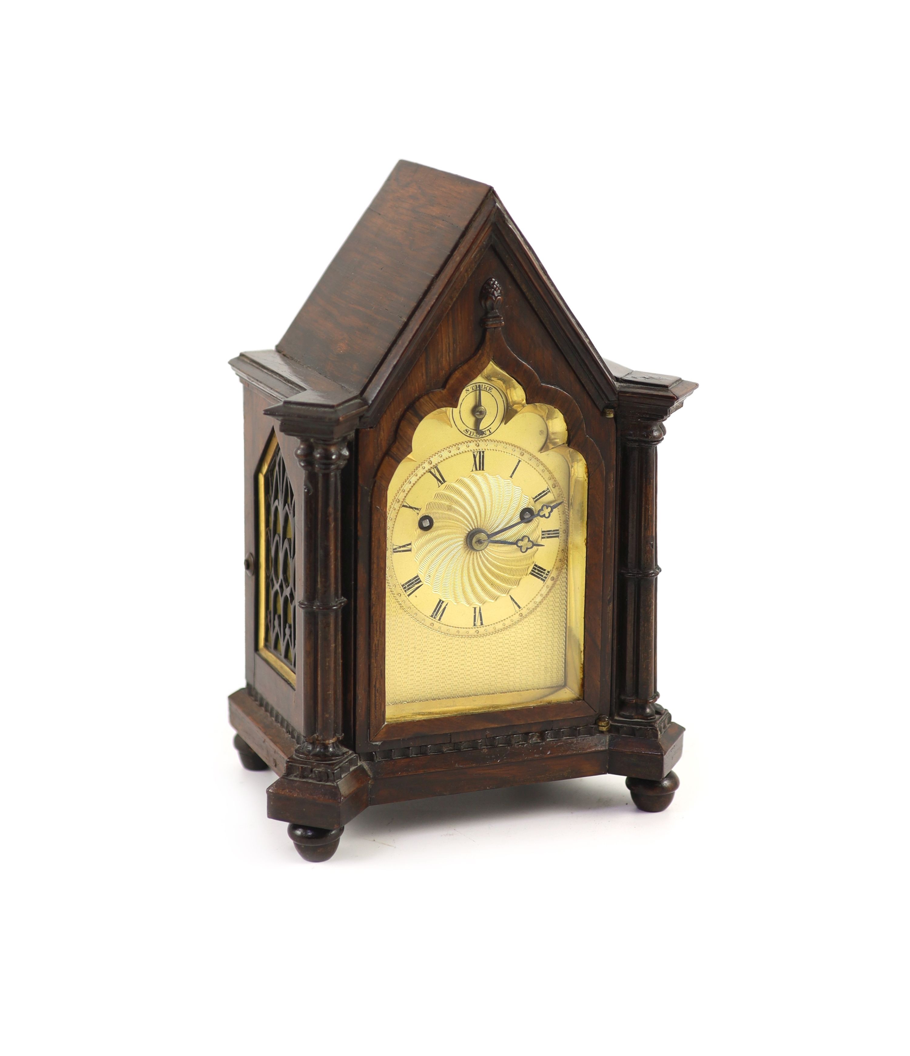An early Victorian gothic revival rosewood mantle clock,with Gothic lancet case and gilt engine