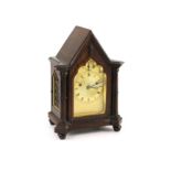 An early Victorian gothic revival rosewood mantle clock,with Gothic lancet case and gilt engine