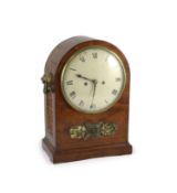 A George III mahogany bracket clock,the arched cased with foliate mount and lion's mask ring handles