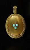 A Victorian gold and three stone turquoise set oval locket,with cannetille style border decoration