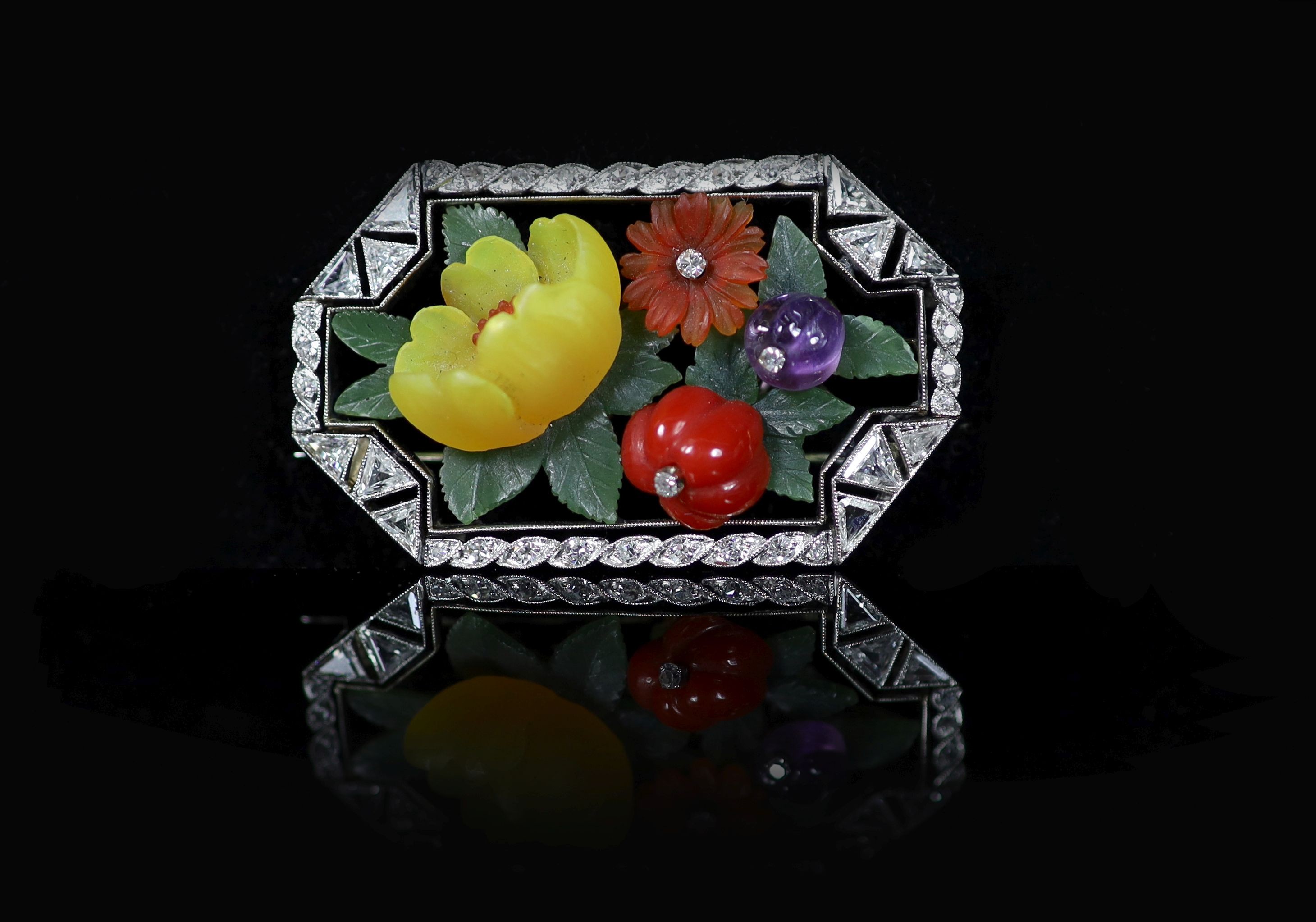 An Art Deco white gold, diamond, coral, amethyst and coloured frosted glass set octagonal brooch, by