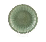 A Chinese Ming Longquan celadon dish, 15th/16th century,of petal lobed form the centre moulded