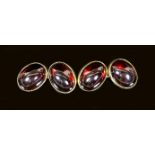 A pair of early 1960's 18ct gold and cabochon garnet set oval cufflinks,12mm, gross weight 22.5
