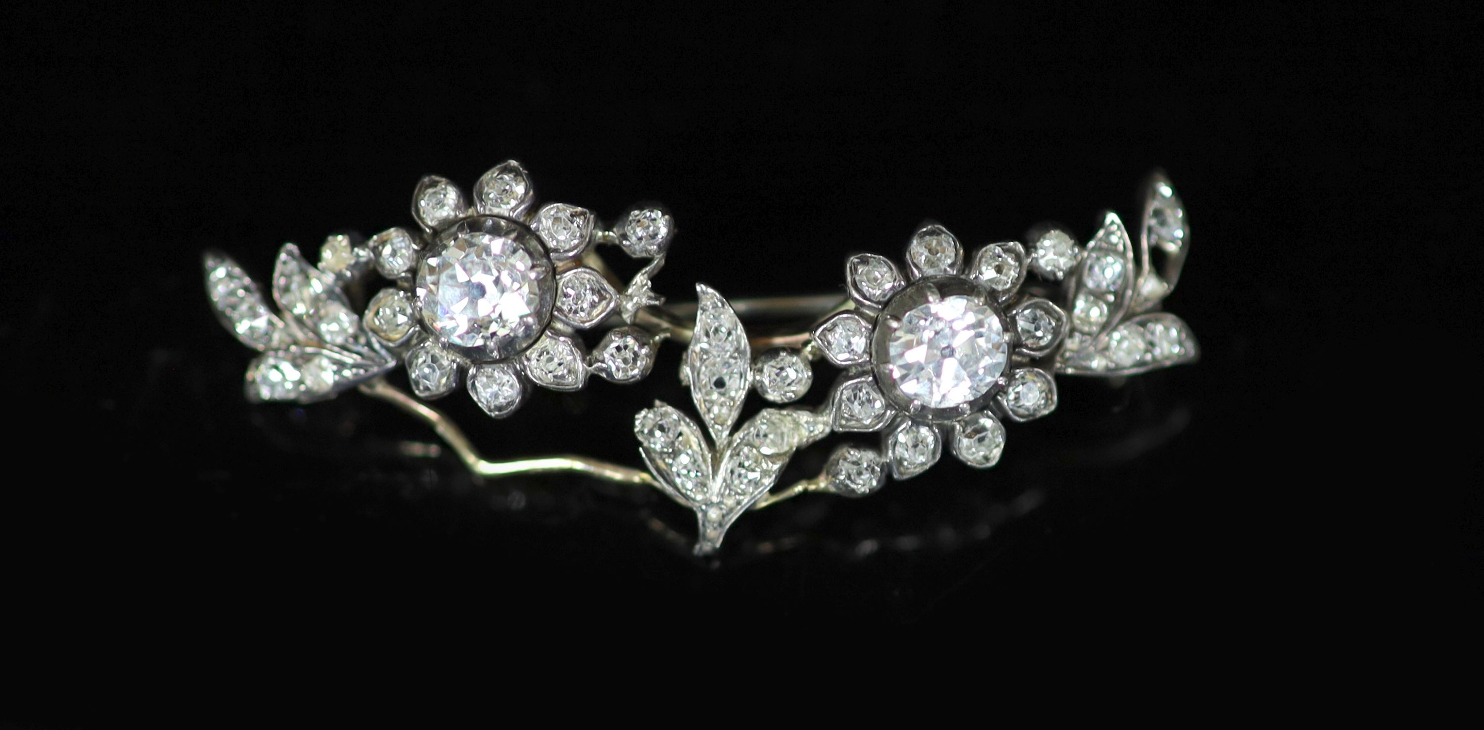 A late Victorian gold, silver and diamond cluster set foliate broochthe two largest diamonds