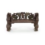 An early 20th century Black Forest carved wood bear hall seat,the vineous carved back centred with a