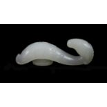 A Chinese white jade 'ram’s head’ belt hook,the scrolled belt hook carved in relief with tight