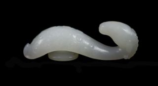 A Chinese white jade 'ram’s head’ belt hook,the scrolled belt hook carved in relief with tight