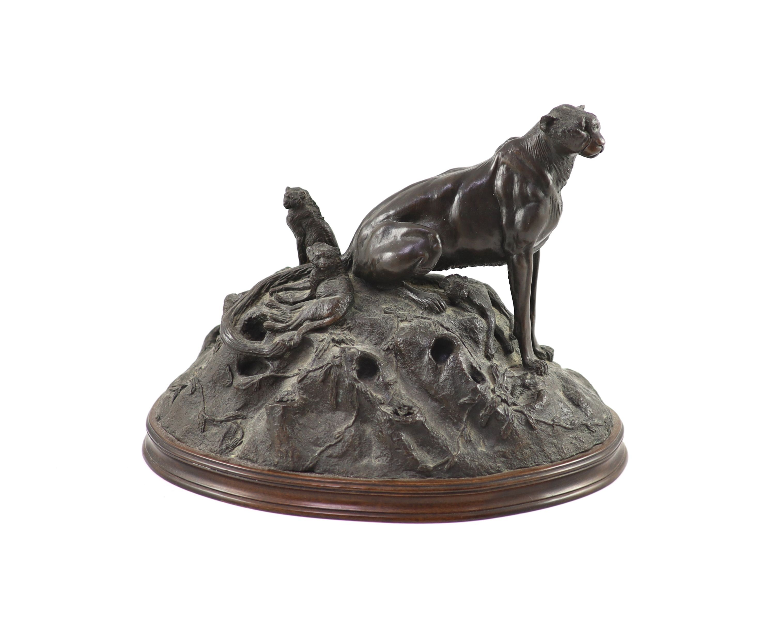 Tim Nicklin. A bronze group of a cheetah and her cubsseated upon a naturalistic mount, signed and