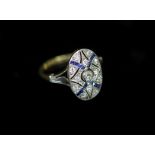 A 1920's gold and platinum, sapphire and diamond millegrain set pierced oval dress ring,size J/K,